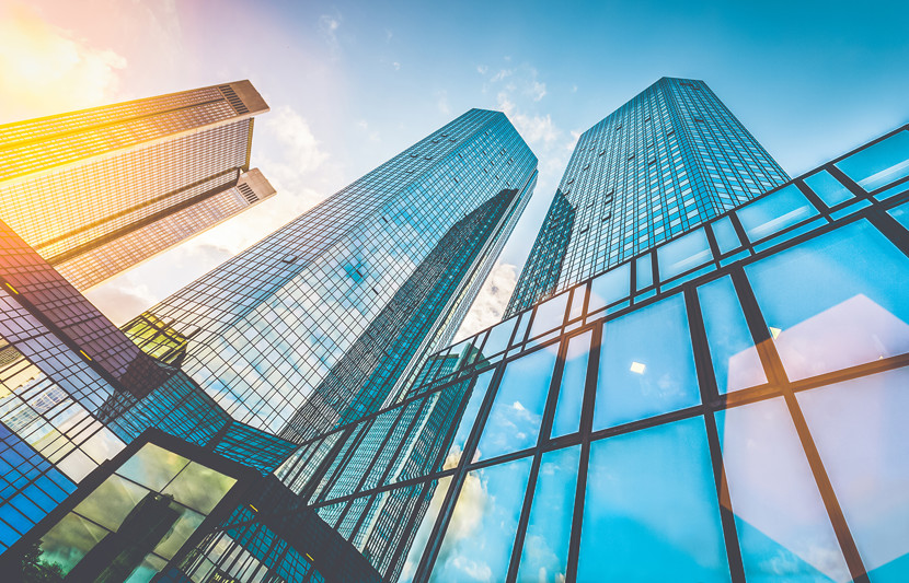 Modern skyscrapers in business district at sunset with lens flare effect 