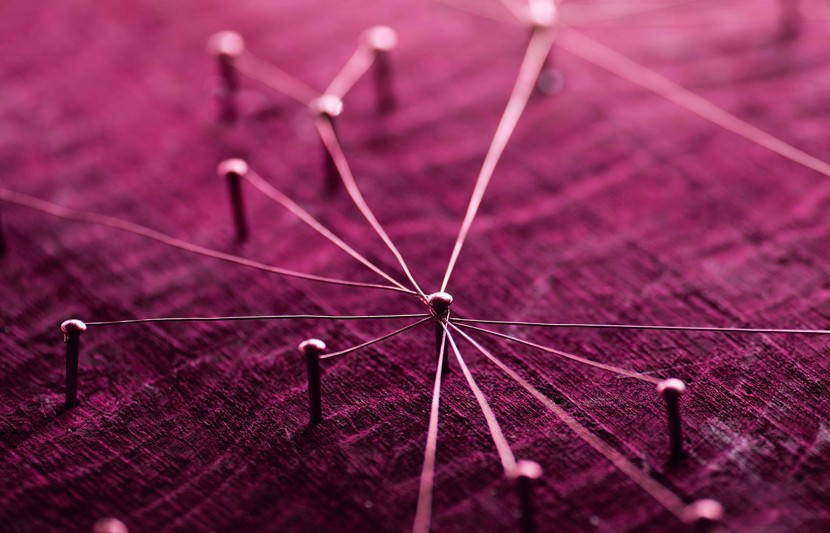 Pins in plum coloured board representing a network for fast tracked infrastructure