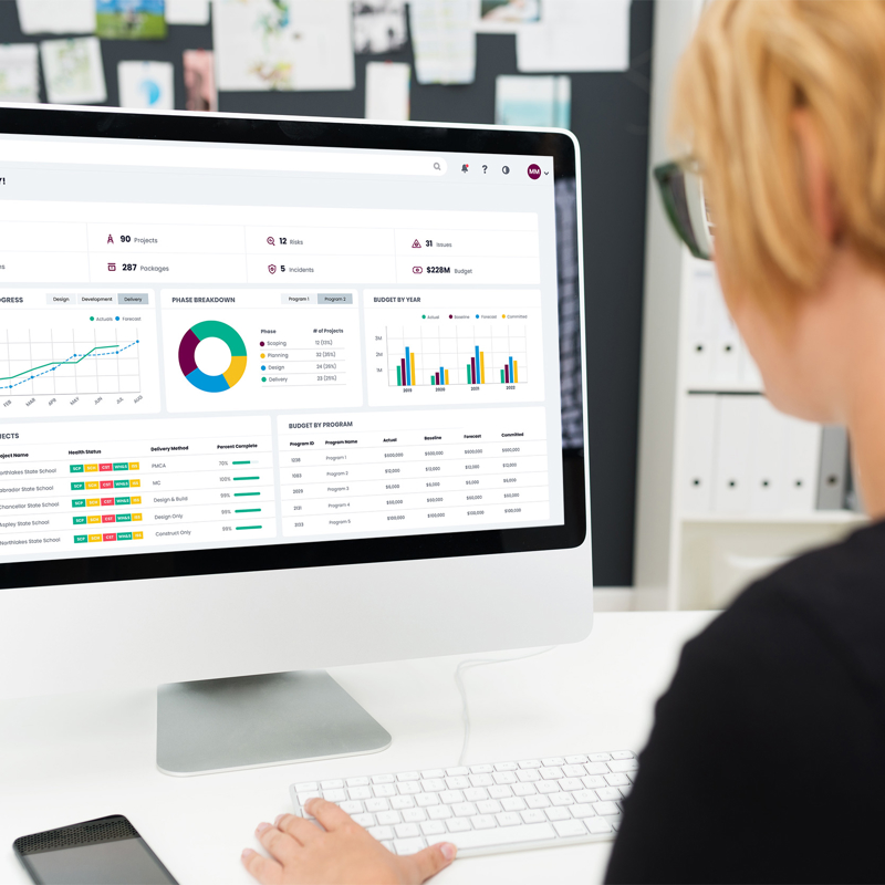 Woman using myProjects software and looking at project dashboard on computer