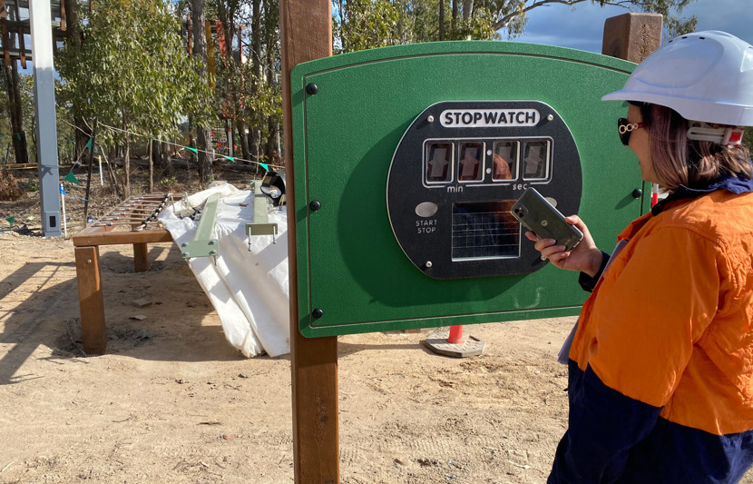 RPS landscape architect stands in front of a large 'Stop Watch' time counter which has been erected on a green post.  