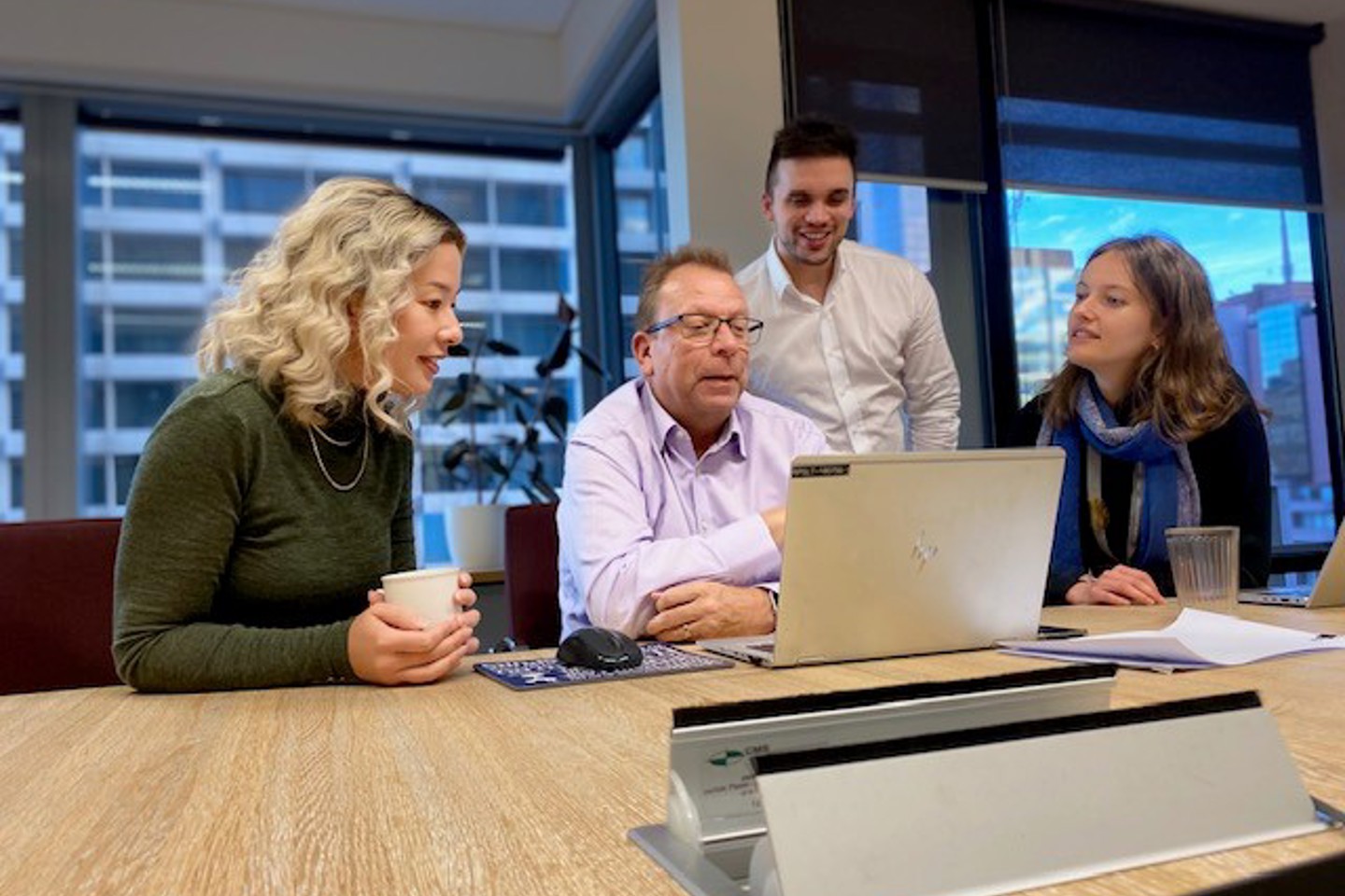 Four commercial advisory team members have an online meeting in boardroom