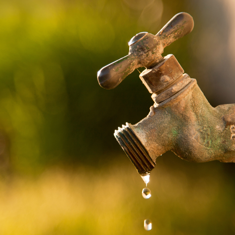 Water drips from a tap